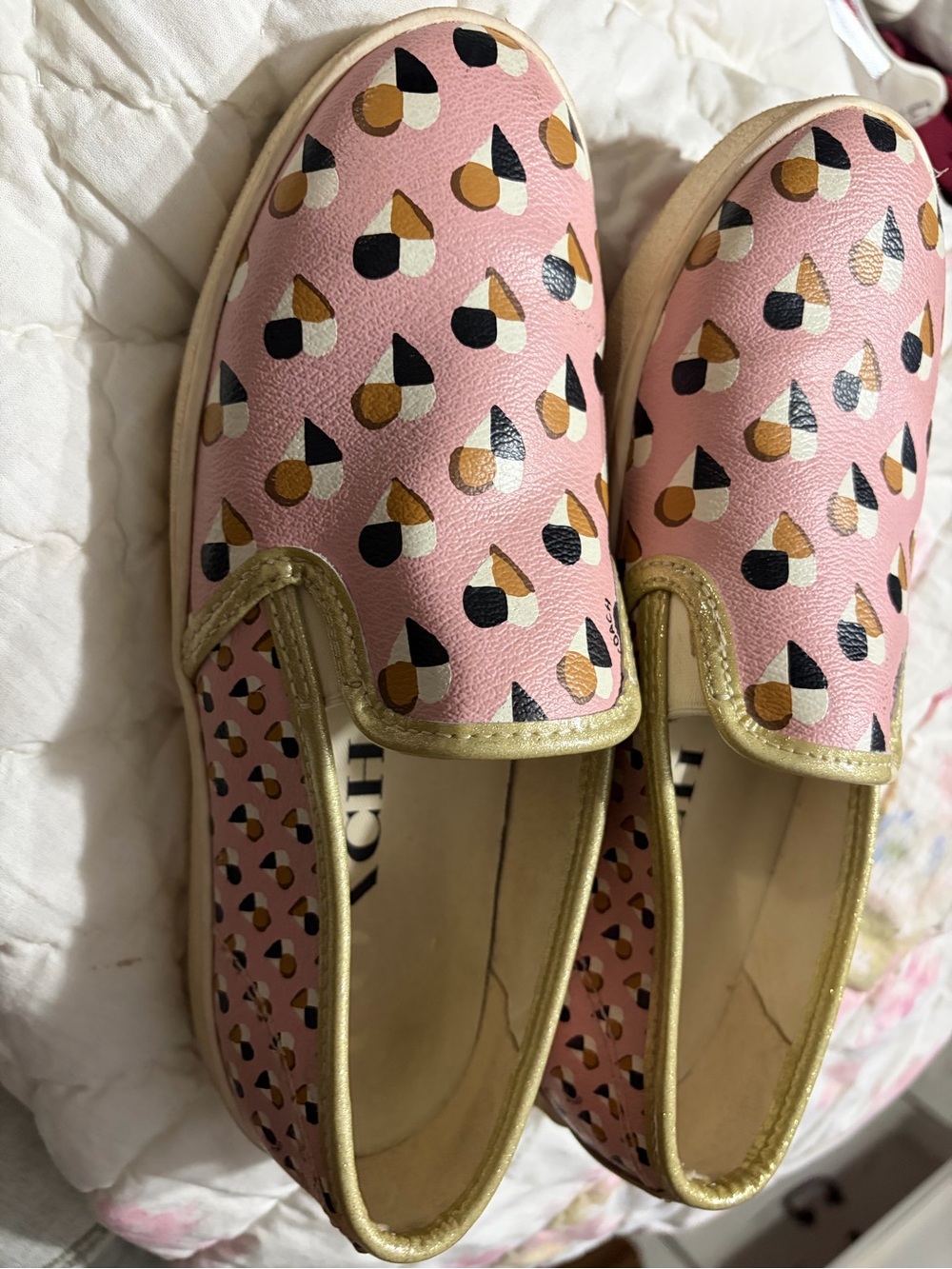 Coach Pink Slip-On Sneakers with Gold Trim and Multi-Color Print